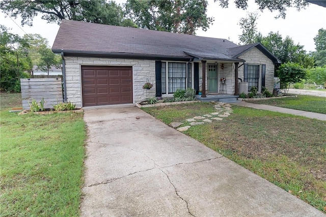 ranch-style house featuring a front yard and a garage