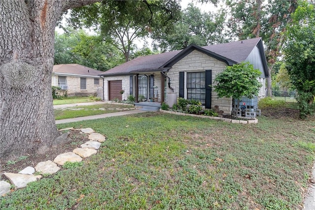 single story home with a garage and a front yard