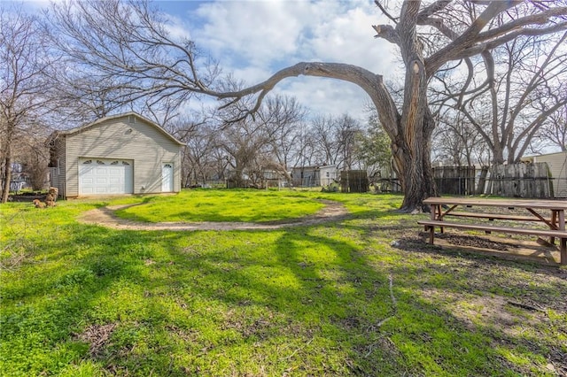 view of yard featuring a garage and an outdoor structure