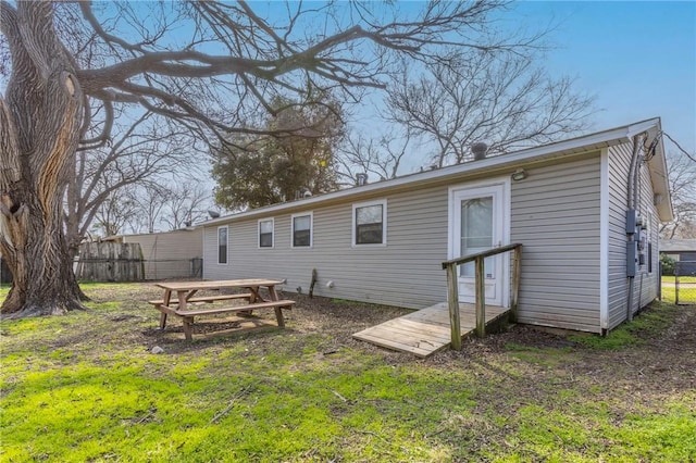 rear view of house featuring a lawn