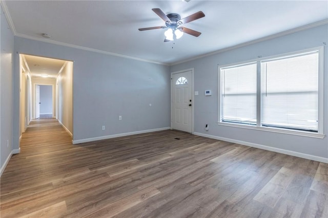 entrance foyer with ornamental molding, wood-type flooring, and ceiling fan