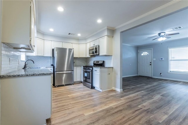 kitchen with sink, stainless steel appliances, and white cabinets