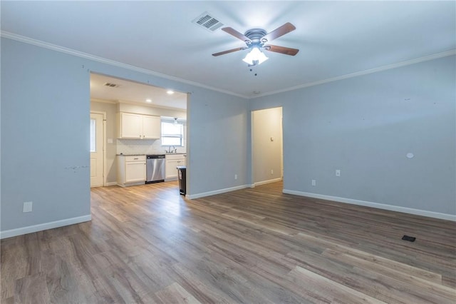 unfurnished living room with ornamental molding, sink, ceiling fan, and light hardwood / wood-style flooring