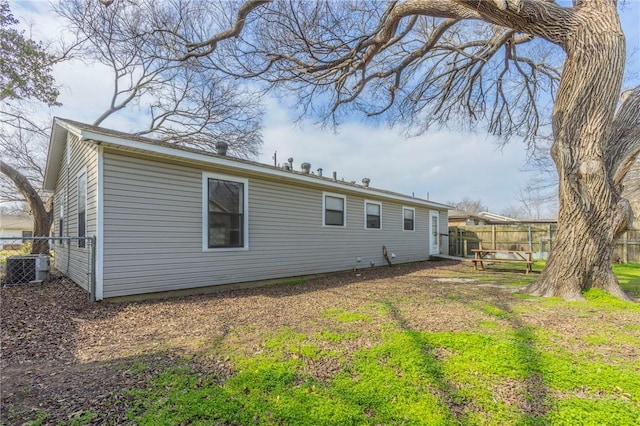 back of property featuring central AC