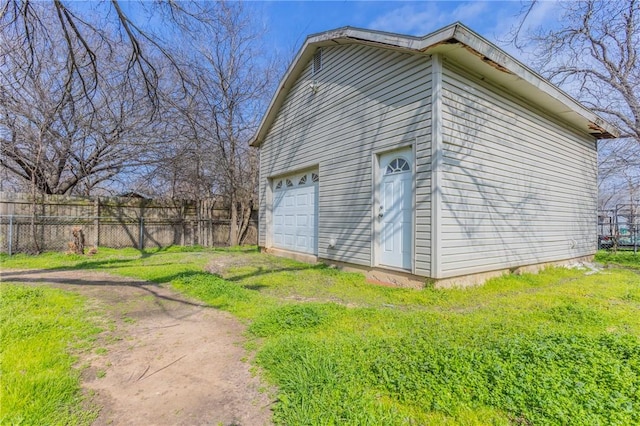 view of side of home featuring a yard, a garage, and an outdoor structure