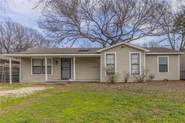 ranch-style house featuring a porch and a front yard