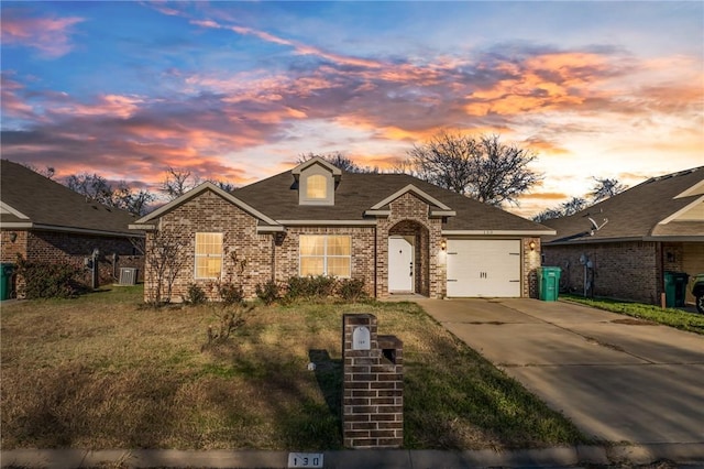 view of front of house with a yard and a garage