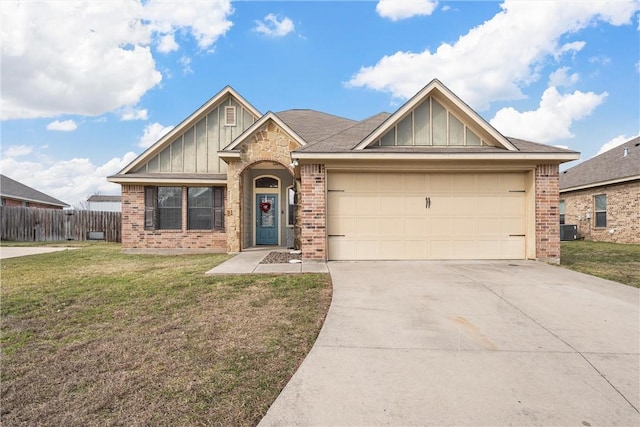 view of front of house featuring a garage, a front yard, and central air condition unit