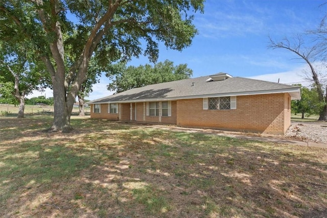 rear view of house with a lawn