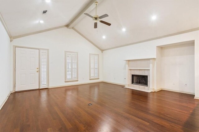 unfurnished living room featuring lofted ceiling, a tiled fireplace, dark hardwood / wood-style floors, and crown molding