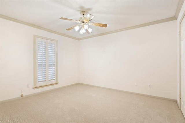 carpeted empty room with crown molding and ceiling fan