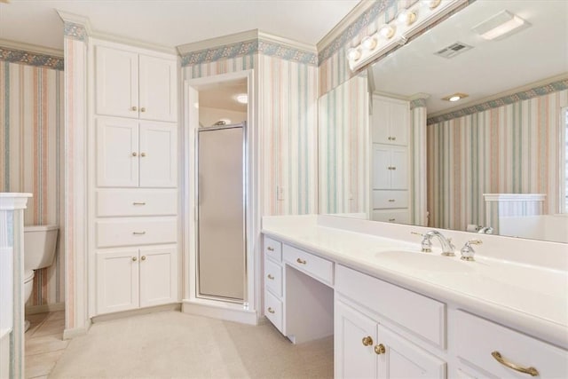 bathroom with vanity, a shower with door, and toilet