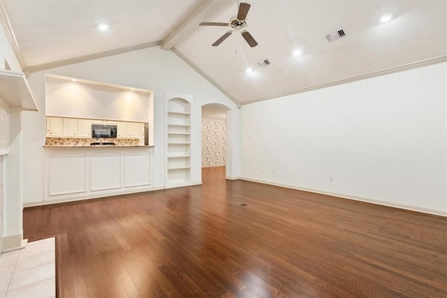 unfurnished living room with built in features, vaulted ceiling with beams, ornamental molding, ceiling fan, and light wood-type flooring