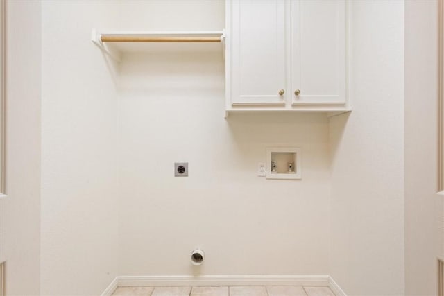 washroom with hookup for a washing machine, electric dryer hookup, light tile patterned floors, and cabinets