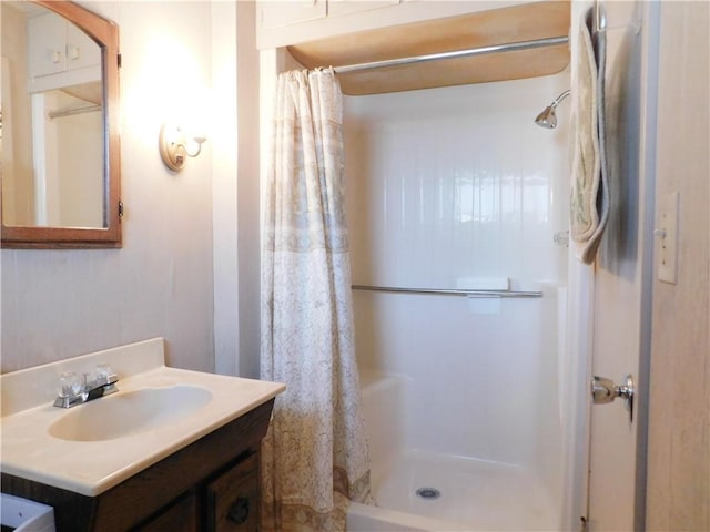 bathroom featuring curtained shower and vanity