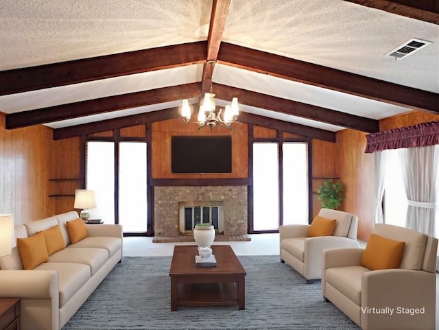 carpeted living area featuring an inviting chandelier, wooden walls, a fireplace, and visible vents