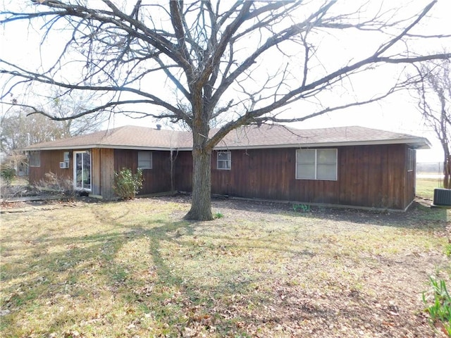 rear view of house with a yard