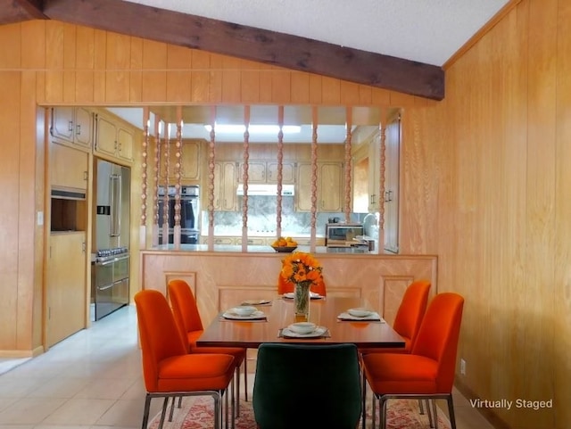 dining room with lofted ceiling with beams and wood walls