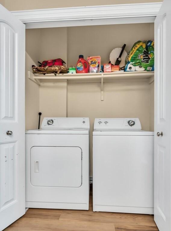 laundry room featuring hardwood / wood-style flooring and washing machine and dryer