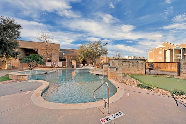 view of pool featuring a patio area and a hot tub