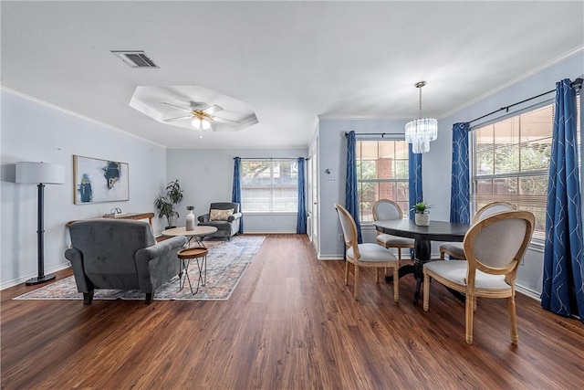 dining room with ceiling fan with notable chandelier, dark hardwood / wood-style floors, and crown molding