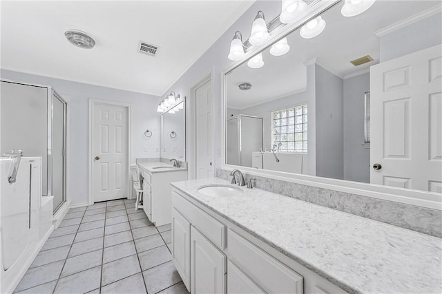 bathroom with tile patterned floors, vanity, crown molding, and walk in shower