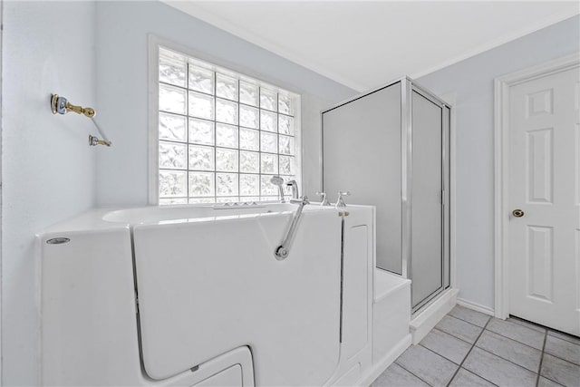 bathroom featuring crown molding, tile patterned flooring, and an enclosed shower