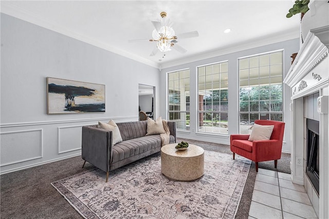 living room with carpet floors, ceiling fan, and crown molding