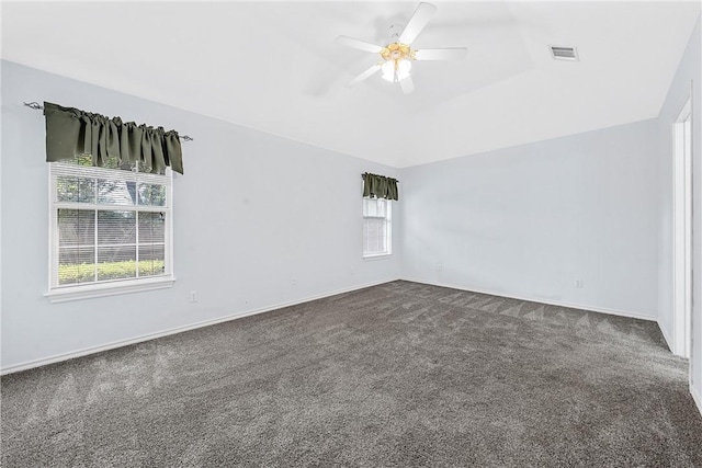 carpeted empty room with ceiling fan and a healthy amount of sunlight