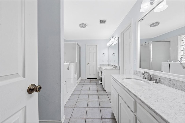 bathroom with tile patterned flooring, vanity, and a shower with shower door