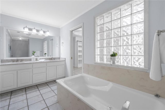 bathroom with tiled bath, crown molding, tile patterned flooring, and vanity