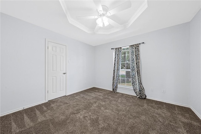 carpeted empty room with a tray ceiling, ceiling fan, and crown molding