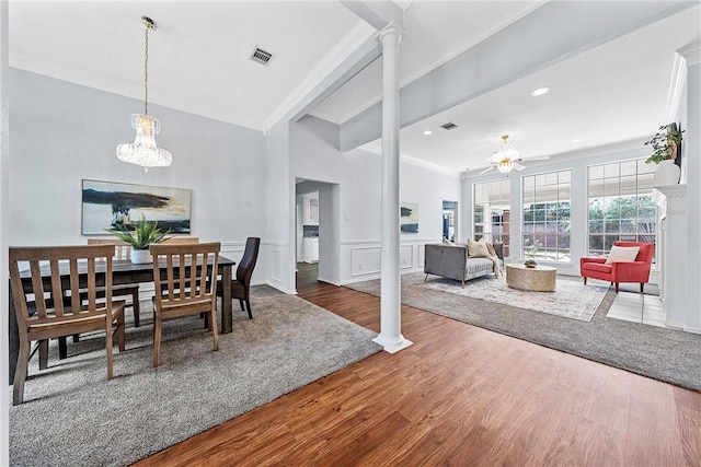 dining area with beamed ceiling, wood-type flooring, ceiling fan with notable chandelier, and decorative columns