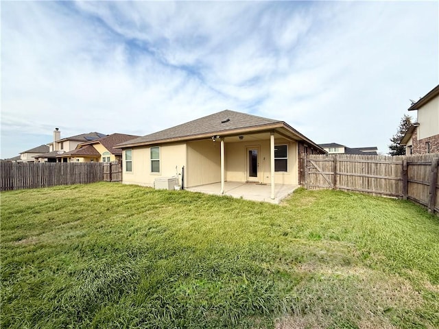 rear view of house with a yard and a patio area