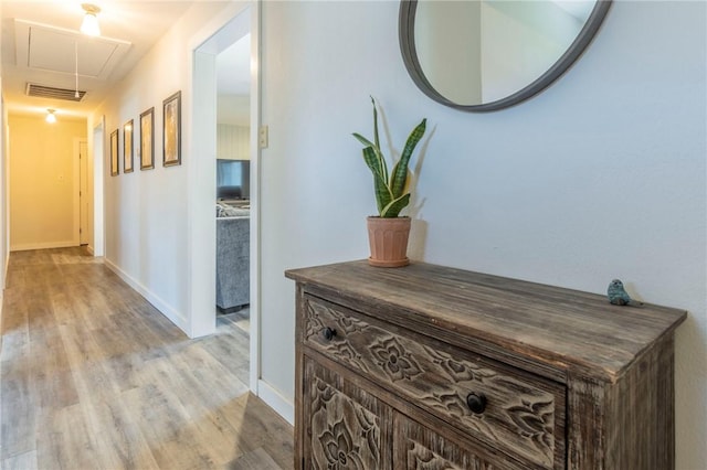 hallway with light hardwood / wood-style flooring