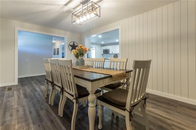 dining space featuring dark hardwood / wood-style floors