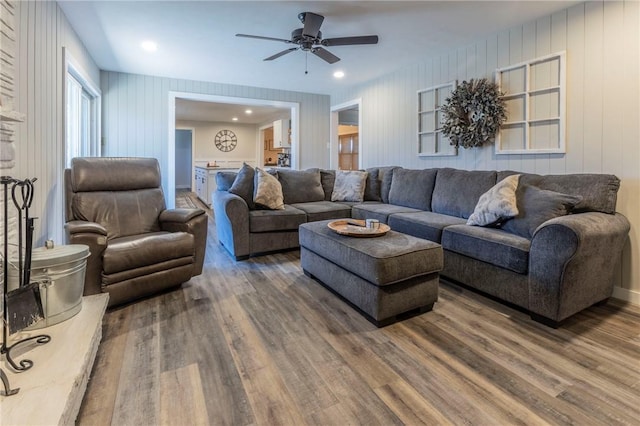 living room with ceiling fan and dark hardwood / wood-style flooring