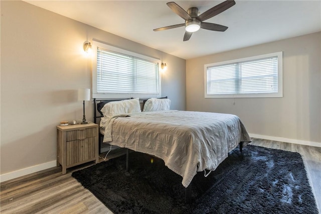 bedroom with hardwood / wood-style flooring and ceiling fan