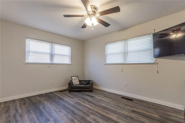 unfurnished room with dark hardwood / wood-style flooring and ceiling fan