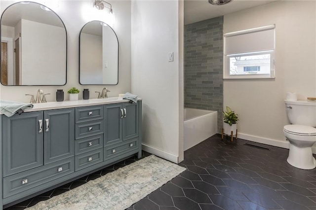 full bathroom with tiled shower / bath, vanity, toilet, and tile patterned flooring