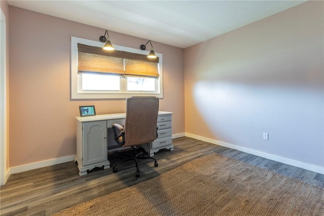 home office with dark hardwood / wood-style floors