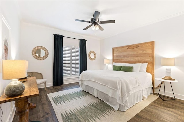 bedroom featuring dark hardwood / wood-style floors, ceiling fan, and crown molding