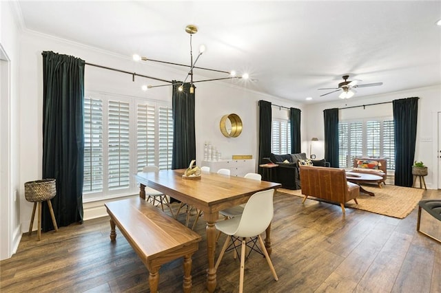 dining area with dark hardwood / wood-style floors, ceiling fan with notable chandelier, and ornamental molding