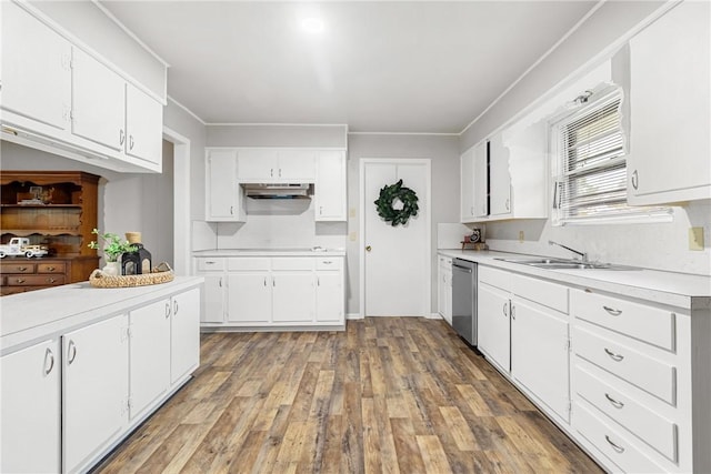 kitchen with stainless steel dishwasher, ornamental molding, dark wood-type flooring, sink, and white cabinetry