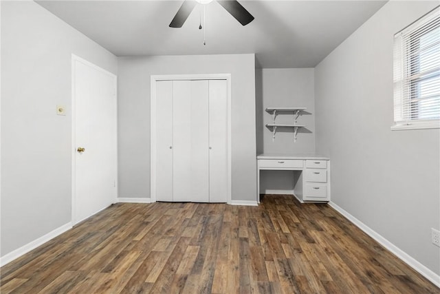 unfurnished bedroom featuring a closet, ceiling fan, and dark hardwood / wood-style flooring