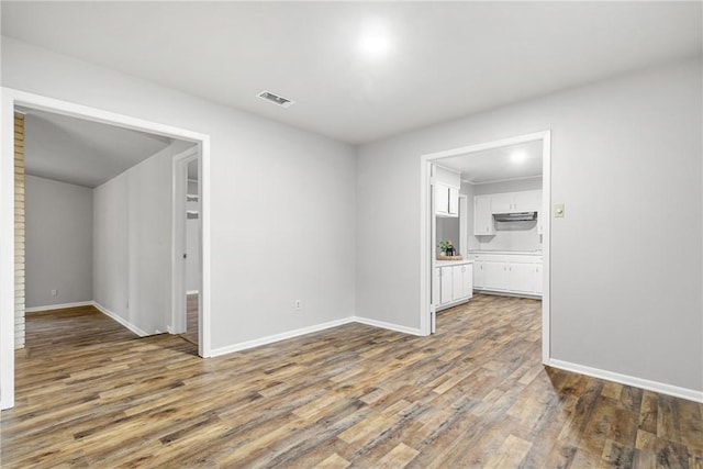 empty room featuring dark wood-type flooring