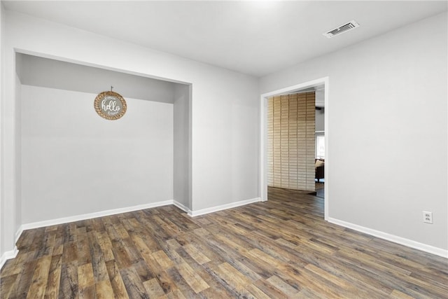 spare room with dark wood-type flooring