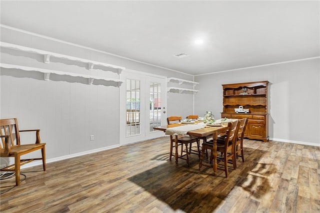 dining room featuring crown molding, dark wood-type flooring, and french doors