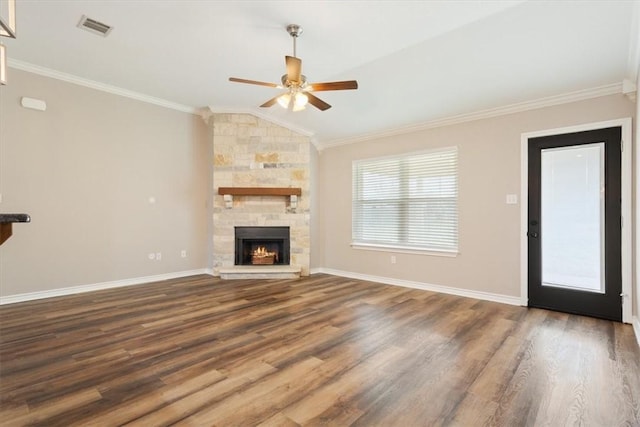 unfurnished living room featuring baseboards, visible vents, lofted ceiling, crown molding, and a fireplace