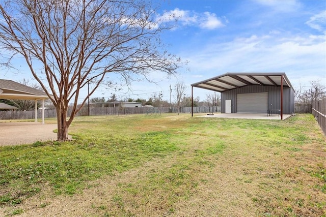 view of yard with an outbuilding, fence, and a garage